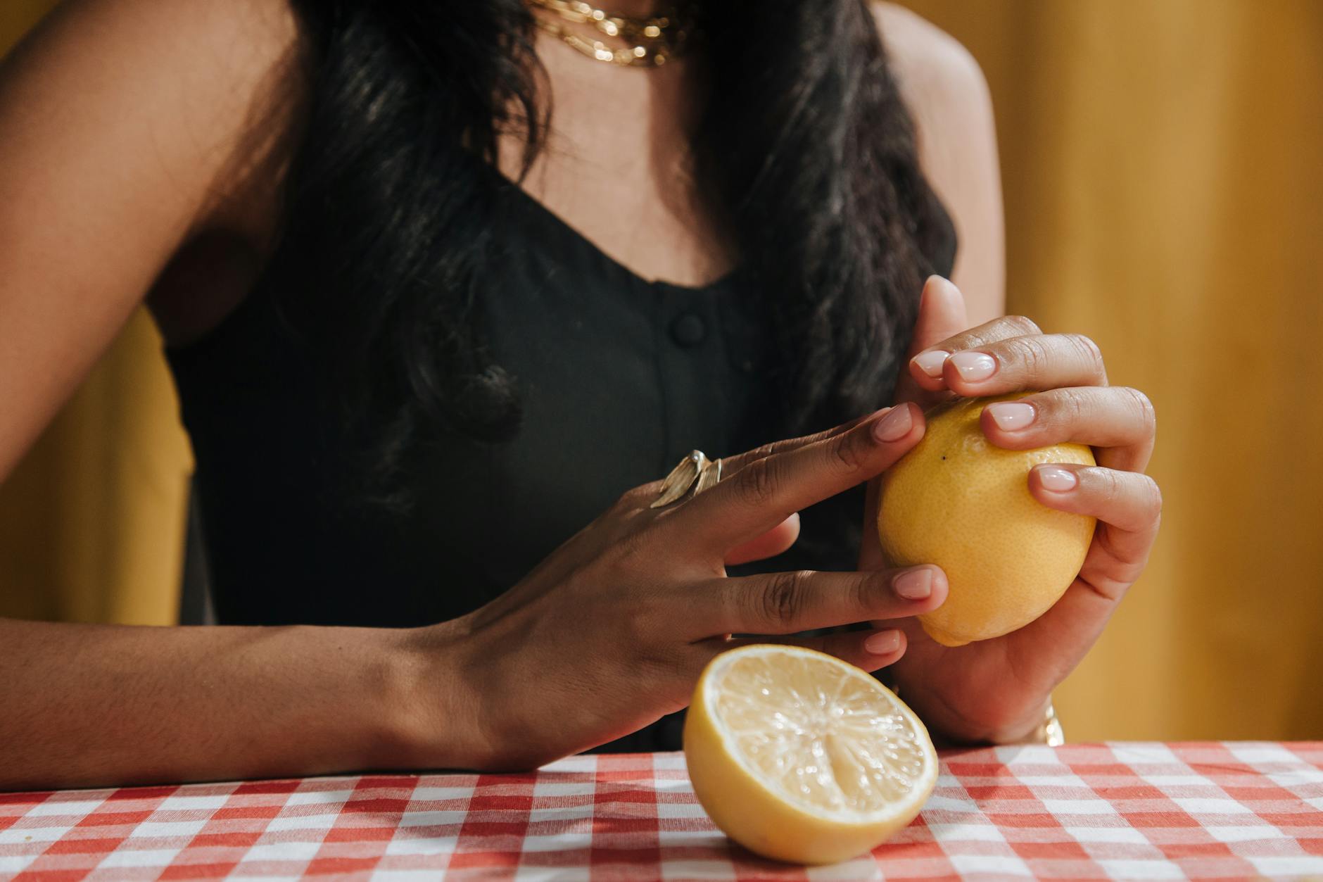Woman holding a vibrator in contemplative pose, exploring solo pleasure