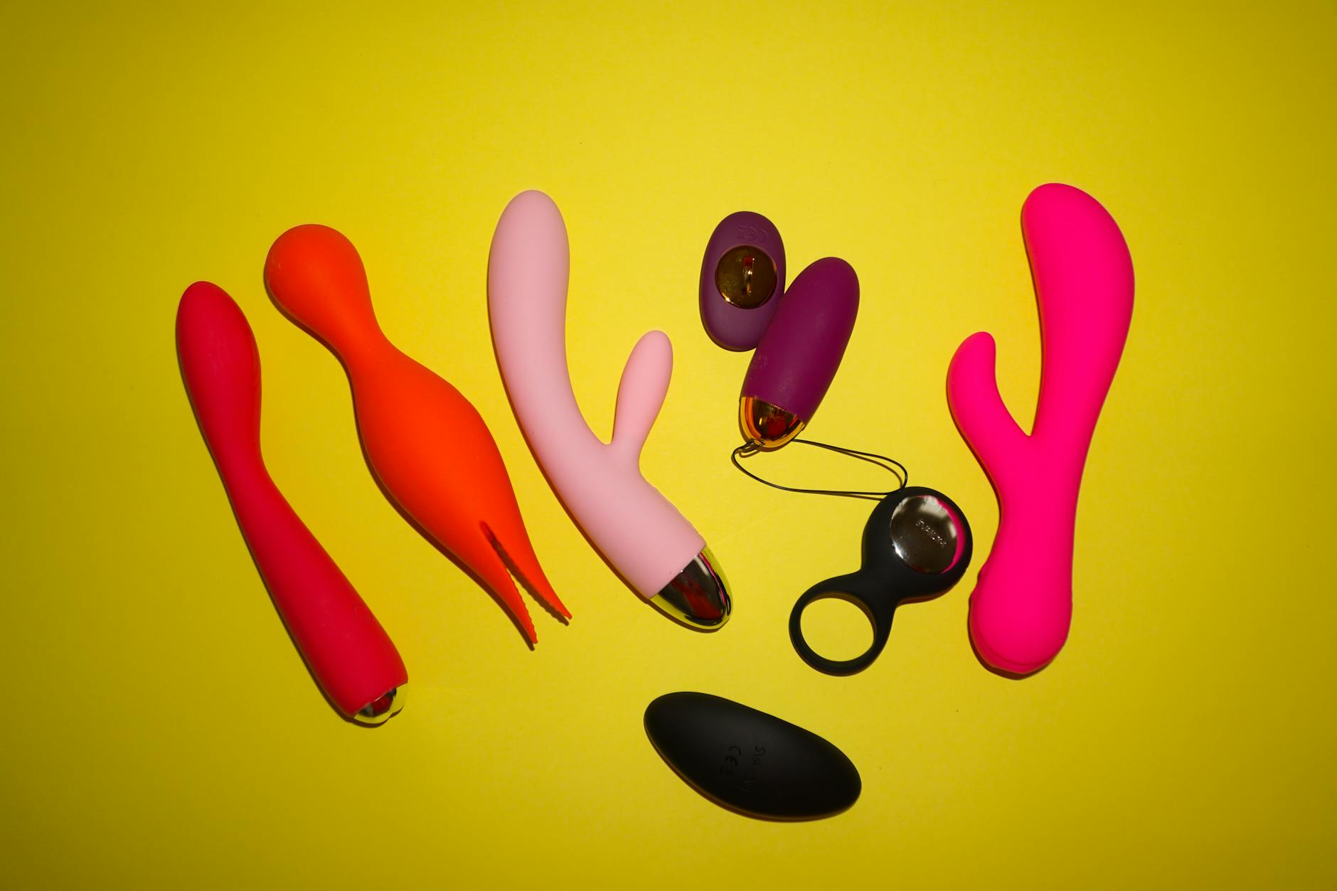 Hand holding a blue silicone vibrator against a purple background, symbolizing self-directed pleasure and bodily autonomy