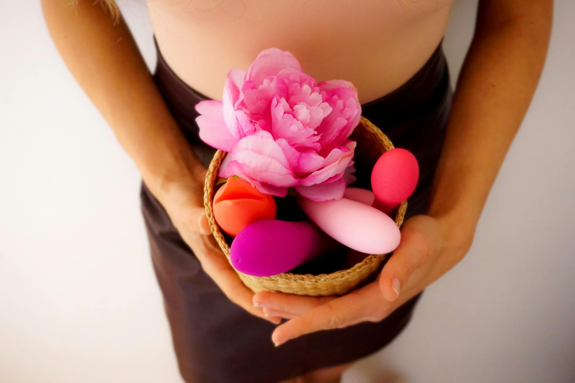 Vibrant assortment of colorful vibrators on a bright yellow surface, representing diverse pleasure styles and options
