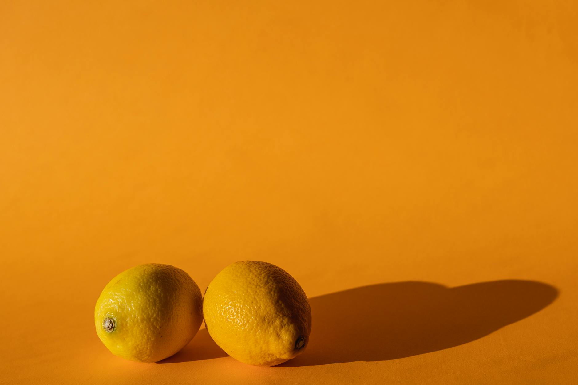 Ripe vivid lemons composed on yellow background symbolizing fresh approaches to pleasure