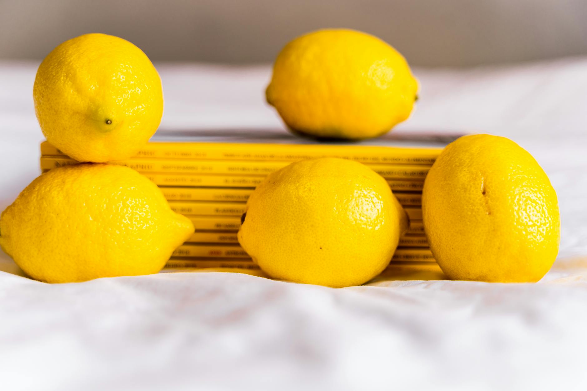Fresh lemons arranged with books, symbolizing the layered complexity of perimenopause and pleasure